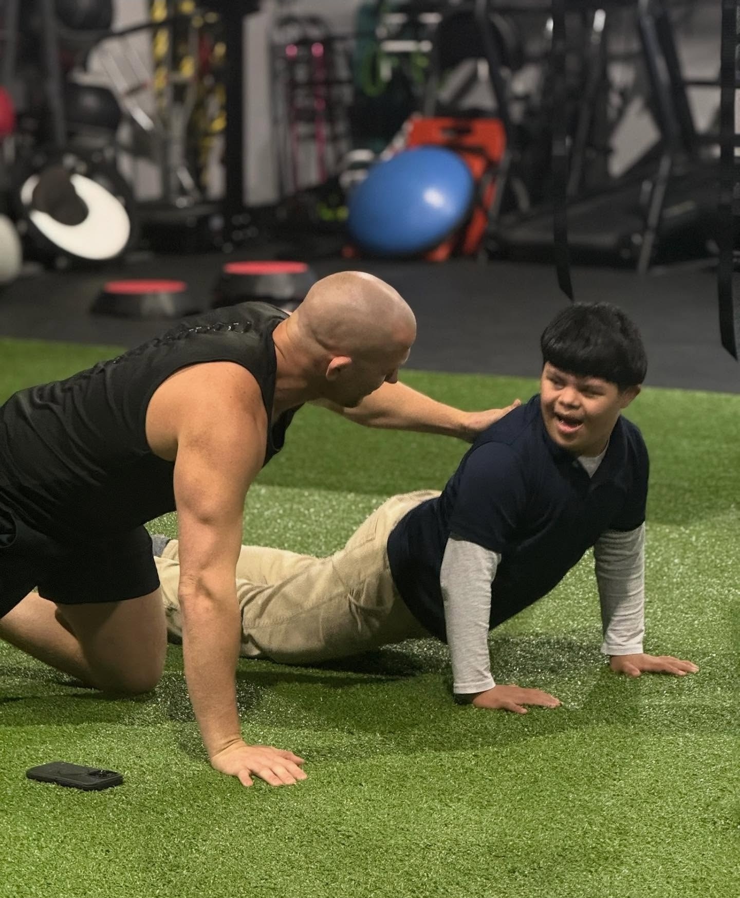 Damon coaching an athlete through push-ups