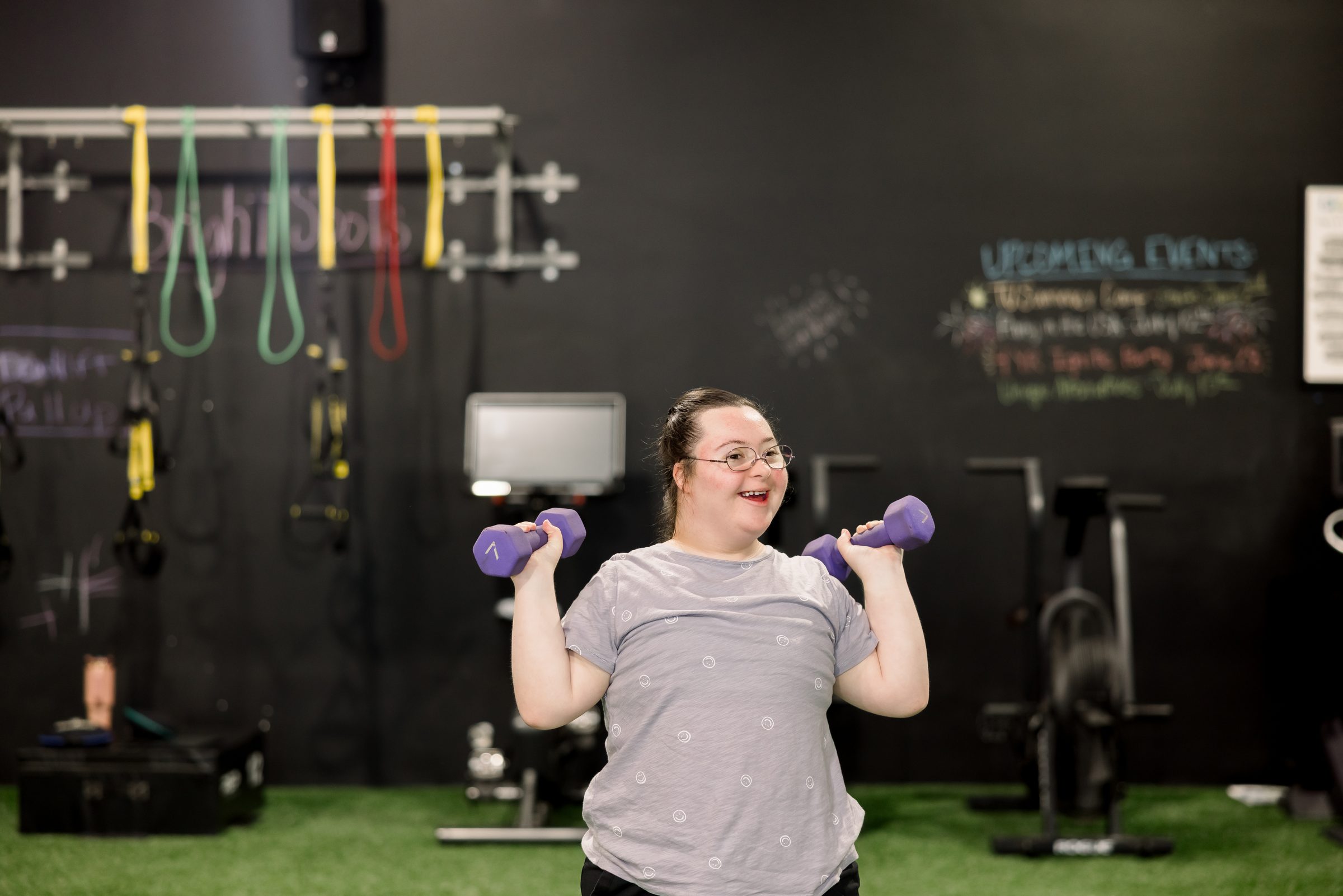 An athlete pressing dumbbells overhead